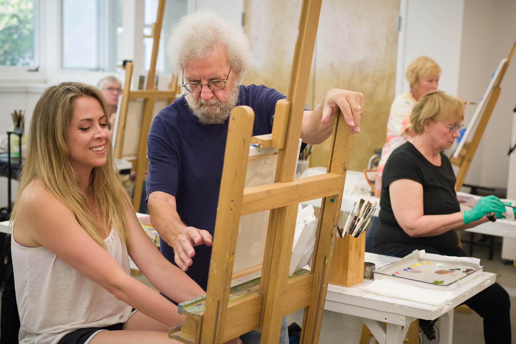 Instructor Bud Deihl helps an oil painting student during one of the many classes offered at Valley Art Center. Photo by Valley Art Center / Michael Steinberg